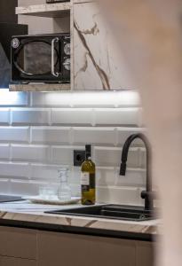 a bottle of wine sitting next to a kitchen sink at Margianna's Cupola Luxury Residence in Rethymno