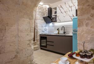 a kitchen with a blue refrigerator and a table at Margianna's Cupola Luxury Residence in Rethymno