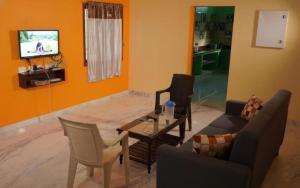 a living room with a couch and a table at De Majestic SSK Paradise Beach Villa in Pondicherry