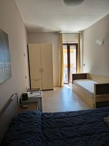 a bedroom with a bed and a cabinet in it at BrezzaMarina in Sapri