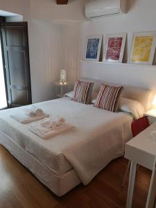 a bedroom with a large bed with towels on it at Altevolte Rooms in Catania