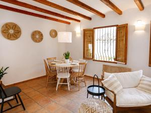 a living room with a table and chairs at Casa en Bellaguarda by NRAS in Altea
