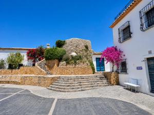 a building with stairs in front of a building at Casa en Bellaguarda by NRAS in Altea
