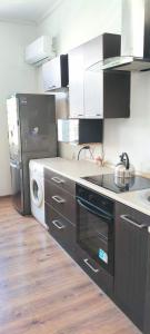 a kitchen with a refrigerator and a washer and dryer at Essa apartament in Brzeg +2 photos