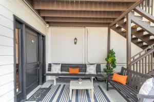 a porch with a bench and a table at Rutledge After Dark - Walk to Broadway & The Gulch in Nashville