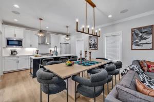 a kitchen and living room with a table and chairs at Resonant - 2 Townhomes - 2 Private Rooftop Decks in Nashville