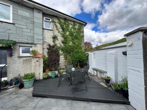 a patio with a table and chairs in front of a house at Jakanori in Staveley