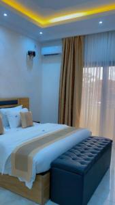 a bedroom with a large bed and a window at Hôtel La Miséricorde in Douala +5 photos