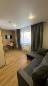 a living room with a couch and a table at Alsun Hotel in Astana