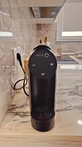 a black appliance sitting on top of a counter at Lugar de São Braz in Alter do Chão +19 photos