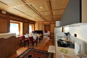 a kitchen and dining room with a table and chairs at Residenza Loo Bach n 8 in Gressoney-Saint-Jean +13 photos