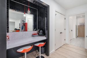 a kitchen with two orange stools and a counter at Hyve-Retro Modern-Full Gym-Walk to Broadway in Nashville