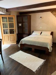 a bedroom with a large bed and a wooden floor at Apartments Šmit in Cres