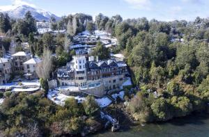 an aerial view of a large house on a mountain at El Faro Boutique Hotel & Spa by DON in Villa La Angostura