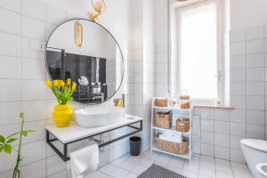 a bathroom with a sink and a mirror at Henry's House Parma in Parma