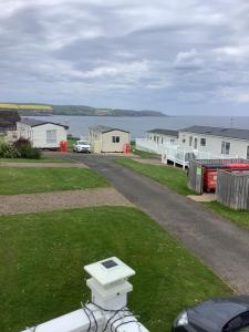 a house yard with a generator on the grass at Home from Home in Eyemouth
