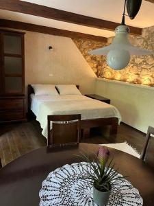 a bedroom with a bed and a table with a potted plant at Apartments Šmit in Cres