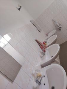 a bathroom with two toilets and a sink and a sink at Hostel Drahonice in Drahonice