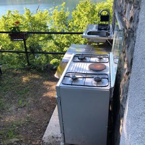 an old stove is on the side of a house at Milly Lake in Claino