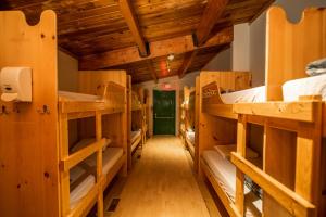 a room filled with lots of wooden bunk beds at HI Kananaskis Wilderness - Hostel in Kananaskis Village +20 photos