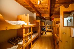 a room with several bunk beds in a cabin at HI Kananaskis Wilderness - Hostel in Kananaskis Village