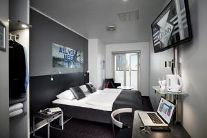 a hotel room with a bed and a desk at Cabinn Aarhus in Aarhus