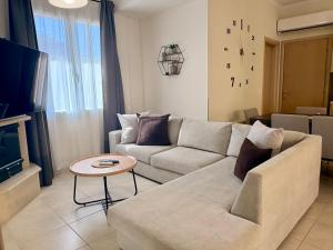 a living room with a couch and a table at Little Spyrela in Sinarádes