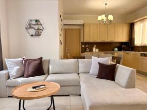 a living room with a couch and a table at Little Spyrela in Sinarádes
