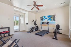 a gym with several exercise bikes and a ceiling fan at Panorama View - Mountain Views - Community Pool in Fountain Hills