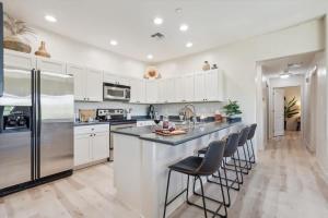 a kitchen with white cabinets and stainless steel appliances at Panorama View - Mountain Views - Community Pool in Fountain Hills +51 photos