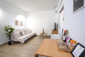 a living room with a couch and a table at Silent Paradise Drago Complex in Costa Del Silencio