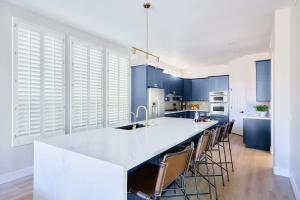 a kitchen with blue cabinets and a white counter top at Citrus-Pool & Spa-Walk 2 restaurants, shops & bars in Phoenix
