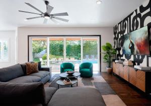 a living room with a couch and a tv at Contour - Sparkling Pool - Mins to Phoenician Golf in Phoenix