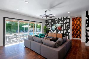 a living room with a couch and a ceiling fan at Contour - Sparkling Pool - Mins to Phoenician Golf in Phoenix