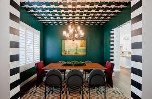 a dining room with green walls and a table and chairs at Contour - Sparkling Pool - Mins to Phoenician Golf in Phoenix
