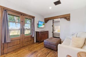 a living room with a white couch and a sliding door at Rhone - In Old Town - Walk to Fashion Square in Scottsdale +49 photos