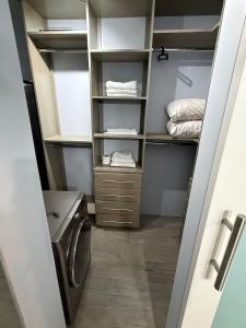 a small laundry room with a washer and dryer at Charm New Kingston in Kingston