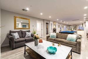a living room with two couches and a table at Pristine Sunset- In Old Town - Private Pool - BBQ in Scottsdale +60 photos