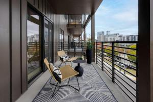 a balcony with two chairs and a table on a building at Hyve - Mahogany - Walk to Broadway in Nashville
