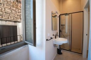 a bathroom with a sink and a glass shower at Borgo Puglia in Bisceglie +63 photos