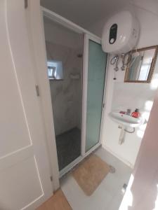 a bathroom with a shower and a sink at FeliGrab in Mindelo