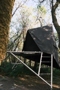 a tent sitting in the woods next to a tree at K-Tent 1 in Treknow