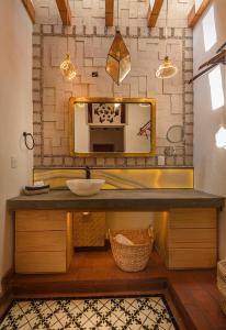 a bathroom with a sink and a mirror at Hotel Boutique Siete Soles in Pátzcuaro +18 photos