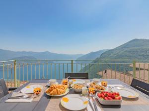 a table with plates of food on top of a balcony at EnjoyIseoLake - Modigliani in Parzanica