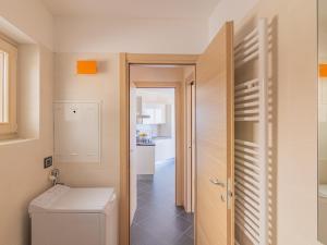 a small bathroom with a toilet and a hallway at EnjoyIseoLake - Modigliani in Parzanica +13 photos