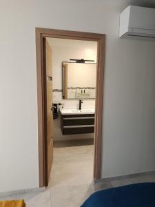 a bathroom with a sink and a mirror at La PETITE MAISON in Gourdan-Polignan +12 photos