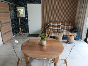 a living room with a table and a couch at La PETITE MAISON in Gourdan-Polignan