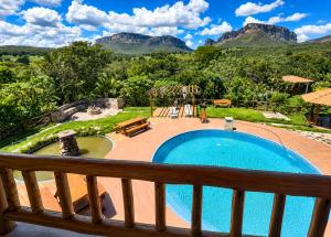 a view from the balcony of a resort with a swimming pool at Recanto Arco Íris in Palmeiras