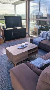 a living room with a couch and a coffee table at Protea House - self-catering house with a Pool in Durban