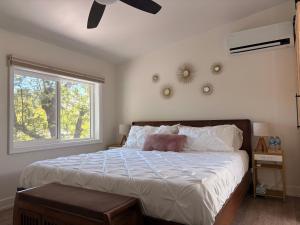 a bedroom with a large bed and a window at Hikari-Okanagan Sunshine B&B in Kelowna +20 photos